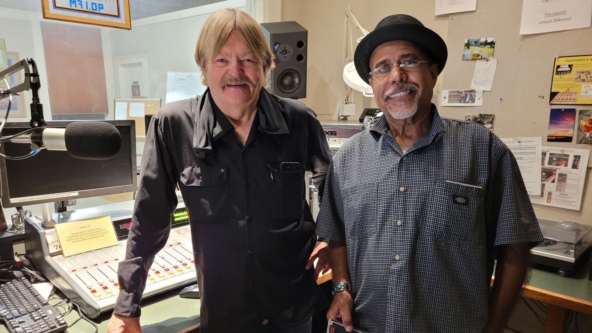 Two KZFR volunteer hosts smiling together in the station studio.